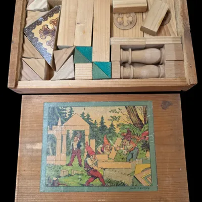 Sale Photo Thumbnail #93: Antique German wooden building block set in its original slide-top box, featuring gnome illustration on the lid.
