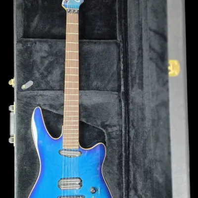 Sale Photo Thumbnail #30: Godin Artisan ST electric guitar in blue sunburst finish, displayed inside its black plush-lined hard shell case.