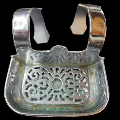 Sale Photo Thumbnail #69: Vintage hanging silver-tone metal soap dish with intricate cutout filigree work and a dual-hook mount, showing light tarnish and patina.