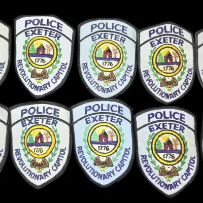 Sale Photo Thumbnail #145: Collection of ten vintage Exeter, New Hampshire police department embroidered patch emblems.