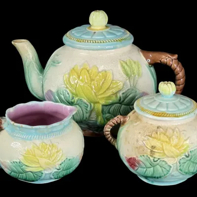Sale Photo Thumbnail #52: Antique Victorian majolica tea set, featuring a teapot, creamer, and covered sugar bowl with relief water lily and pad motifs and twisted faux-twig handles.