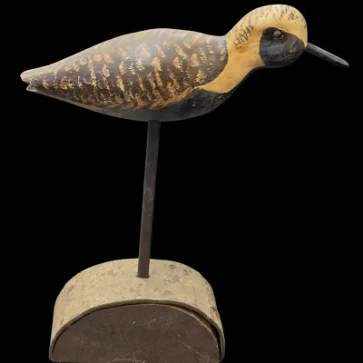 Sale Photo Thumbnail #35: Hand-painted carved wooden shorebird decoy mounted on a metal rod and wooden stand.