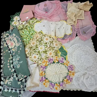 Sale Photo Thumbnail #125: Collection of vintage hand-embroidered, crocheted, and lace linens, including doilies, handkerchiefs, and table runners in various colors.