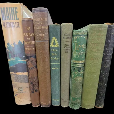 Sale Photo Thumbnail #107: Collection of eight antique and vintage books related to Maine history and literature, including embossed cloth-bound titles like 'Lynx Hunting' and 'The Smugglers of Chestnut'.