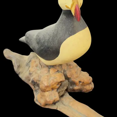 Sale Photo Thumbnail #40: Hand-painted wooden puffin carving mounted on a piece of natural burl wood, featuring detailed bill accents and red bead eyes.