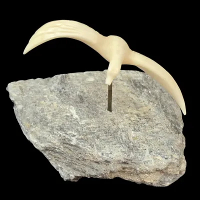 Sale Photo Thumbnail #41: Hand-carved bone or faux-ivory bird in flight mounted on a natural stone base, vintage style.