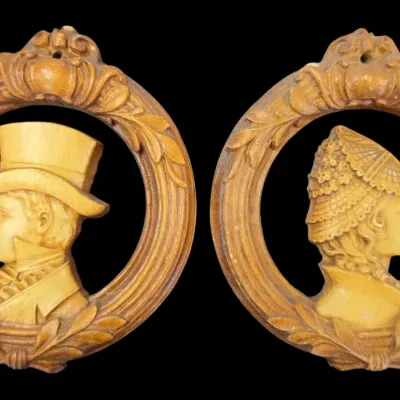 Sale Photo Thumbnail #92: Pair of vintage molded resin wall plaques featuring Victorian-style profile portraits of a man and woman in carved-look oval frames.