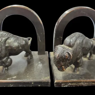 Sale Photo Thumbnail #115: Pair of vintage bronze-finished metal bison bookends with arched backs and detailed relief molding.