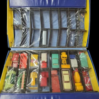 Sale Photo Thumbnail #68: Vintage Matchbox carrying case filled with various Lesney die-cast vehicles, featuring two tiered storage sections.