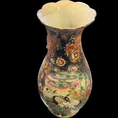 Sale Photo Thumbnail #261: Chinese Satsuma earthenware characterized by its crackle glaze and dense, polychrome enamel decoration. The vase features a lobed rim and a classic baluster form. The body is adorned with intricate scenes including cranes~ a symbol of longevity, flower mo