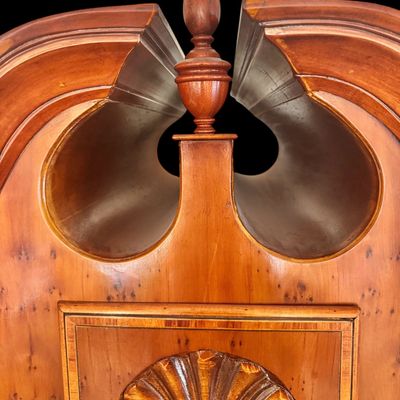 Sale Photo Thumbnail #113: This exquisite Queen Anne style highboy features a classic bonnet-top (or swan's neck) pediment adorned with a central carved shell motif and finials. The piece is constructed with rich, figured walnut veneers, showcasing intricate grain patterns across t