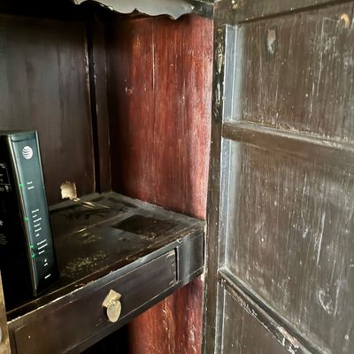 Sale Photo Thumbnail #188: A 19th-century Chinese Shanxi lacquered wood two-part compound wardrobe cabinet. The piece is decorated with traditional motifs including floral arrangements, landscape scenes and figures. It is equipped with ornate brass hardware. The interior features a