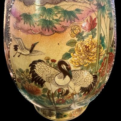 Sale Photo Thumbnail #263: Chinese Satsuma earthenware characterized by its crackle glaze and dense, polychrome enamel decoration. The vase features a lobed rim and a classic baluster form. The body is adorned with intricate scenes including cranes~ a symbol of longevity, flower mo