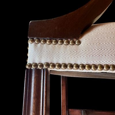 Sale Photo Thumbnail #155: Handsome pair of Chippendale style arm chairs featuring a high, slightly arched back and fluted, dark stained wooden arms and legs. The chairs are upholstered in a neutral chevron pattern fabric, accented with decorative brass tone nailhead trim along the