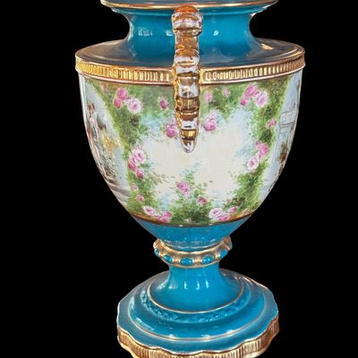 Sale Photo Thumbnail #250: This large decorative French urn features a vibrant teal glazed neck and base, accented with ornate gilded details and handles. The body is decorated with a detailed, hand painted 18th century courting scene. Neo classical design from the late 19th/early 