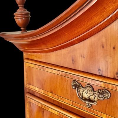 Sale Photo Thumbnail #110: This exquisite Queen Anne style highboy features a classic bonnet-top (or swan's neck) pediment adorned with a central carved shell motif and finials. The piece is constructed with rich, figured walnut veneers, showcasing intricate grain patterns across t