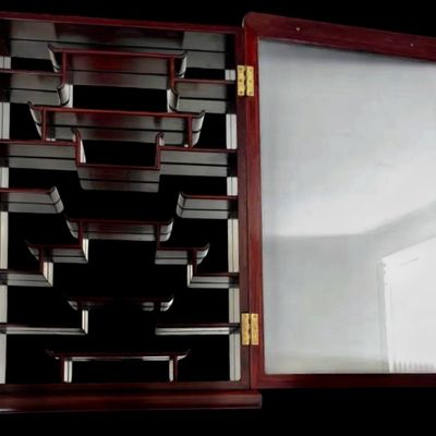 Sale Photo Thumbnail #190: Exquisite wall-mounted curio cabinet, often referred to as a “bogu” shelf constructed from dense rosewood and features intricate beautiful mother-of-pearl inlay. The frame is adorned with delicate floral and avian motifs and enclosed by a glass-fronte
