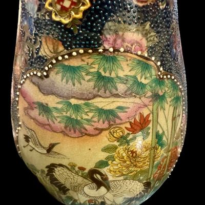 Sale Photo Thumbnail #262: Chinese Satsuma earthenware characterized by its crackle glaze and dense, polychrome enamel decoration. The vase features a lobed rim and a classic baluster form. The body is adorned with intricate scenes including cranes~ a symbol of longevity, flower mo