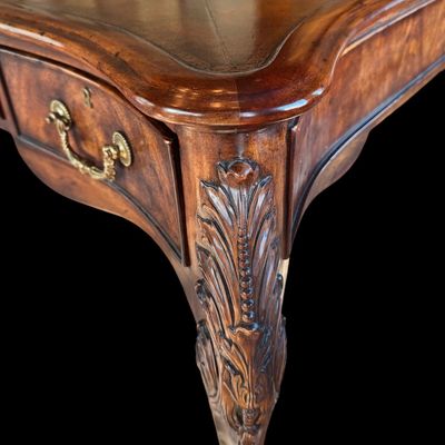 Sale Photo Thumbnail #74: This is a stunning Theodore Alexander partners style writing desk constructed with solid mahogany wood with a beautiful leather tooled top. A rich warm finish showcases the natural grain pattern. The front features a series of 4 drawers equipped with orna