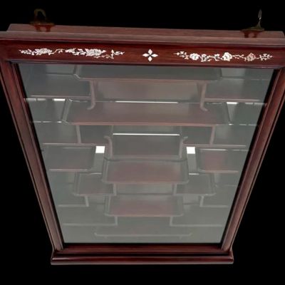 Sale Photo Thumbnail #193: Exquisite wall-mounted curio cabinet, often referred to as a “bogu” shelf constructed from dense rosewood and features intricate beautiful mother-of-pearl inlay. The frame is adorned with delicate floral and avian motifs and enclosed by a glass-fronte