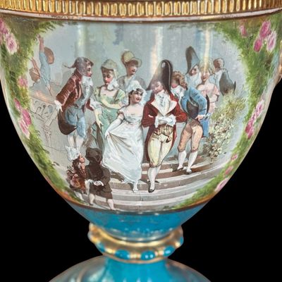 Sale Photo Thumbnail #248: This large decorative French urn features a vibrant teal glazed neck and base, accented with ornate gilded details and handles. The body is decorated with a detailed, hand painted 18th century courting scene. Neo classical design from the late 19th/early 