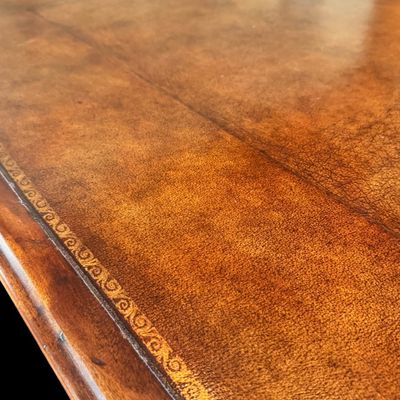 Sale Photo Thumbnail #73: This is a stunning Theodore Alexander partners style writing desk constructed with solid mahogany wood with a beautiful leather tooled top. A rich warm finish showcases the natural grain pattern. The front features a series of 4 drawers equipped with orna