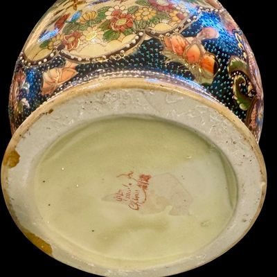 Sale Photo Thumbnail #266: Chinese Satsuma earthenware characterized by its crackle glaze and dense, polychrome enamel decoration. The vase features a lobed rim and a classic baluster form. The body is adorned with intricate scenes including cranes~ a symbol of longevity, flower mo