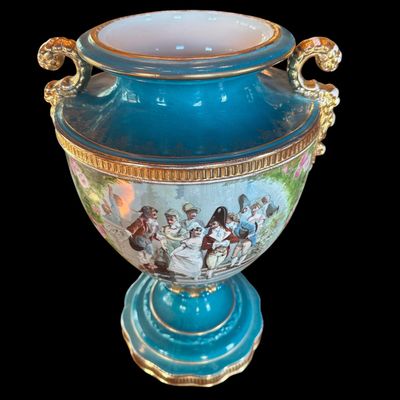 Sale Photo Thumbnail #246: This large decorative French urn features a vibrant teal glazed neck and base, accented with ornate gilded details and handles. The body is decorated with a detailed, hand painted 18th century courting scene. Neo classical design from the late 19th/early 