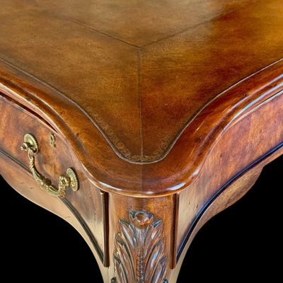 Sale Photo Thumbnail #71: This is a stunning Theodore Alexander partners style writing desk constructed with solid mahogany wood with a beautiful leather tooled top. A rich warm finish showcases the natural grain pattern. The front features a series of 4 drawers equipped with orna