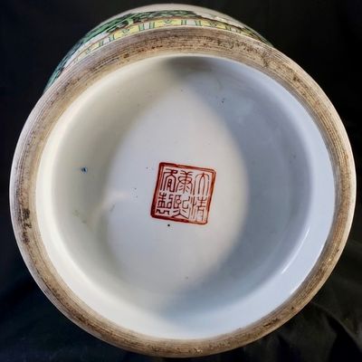 Sale Photo Thumbnail #256: Pair of large, decorative Chinese porcelain vase featuring a black-ground ‘Famille Noire’ palette. The vase showcases intricate polychrome enamel decoration, depicting courtly figures in a garden setting, framed by dense floral and foliate patterns on