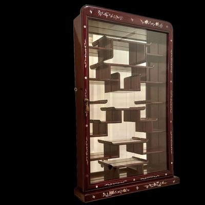 Sale Photo Thumbnail #189: Exquisite wall-mounted curio cabinet, often referred to as a “bogu” shelf constructed from dense rosewood and features intricate beautiful mother-of-pearl inlay. The frame is adorned with delicate floral and avian motifs and enclosed by a glass-fronte