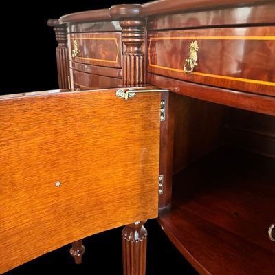 Sale Photo Thumbnail #91: Elegant and high quality Kindel Furniture sideboard executed in the Federal Style with refined neoclassical elements. It features a bow front design, characteristic of the period with flame mahogany veneers, and contrasting stringing inlay. The piece is s
