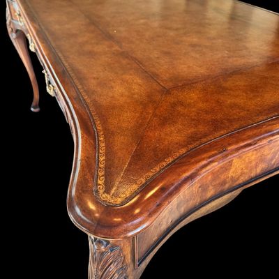 Sale Photo Thumbnail #72: This is a stunning Theodore Alexander partners style writing desk constructed with solid mahogany wood with a beautiful leather tooled top. A rich warm finish showcases the natural grain pattern. The front features a series of 4 drawers equipped with orna
