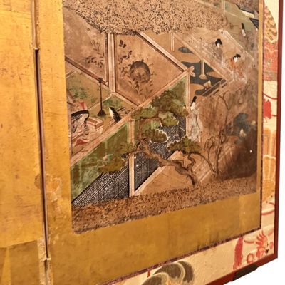 Sale Photo Thumbnail #8: Impressive Japanese eight-panel folding screen featuring hand painted narrative scenes of figures in traditional dress, architecture, and landscapes in muted earth tones with colorful accents. The paintings are framed by gold tone borders, decorative silk