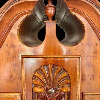 Sale Photo Thumbnail #112: This exquisite Queen Anne style highboy features a classic bonnet-top (or swan's neck) pediment adorned with a central carved shell motif and finials. The piece is constructed with rich, figured walnut veneers, showcasing intricate grain patterns across t