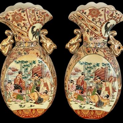 Sale Photo Thumbnail #257: This exquisite pair of Satsuma earthenware vases are characterized by their intricate, multi-colored enamel decoration on a crackle grazed ground. The vase is distinguished by its unique elephant head handles finished in a rich gold luster, reflecting the