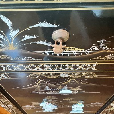 Sale Photo Thumbnail #182: A large black lacquer and mother-of-pearl inlaid figural sideboard depicting the popular “Royal Ladies” narrative scene. Constructed with four central cabinet doors and four upper drawers. The craftsmanship reflects the traditional East Asian furnitur