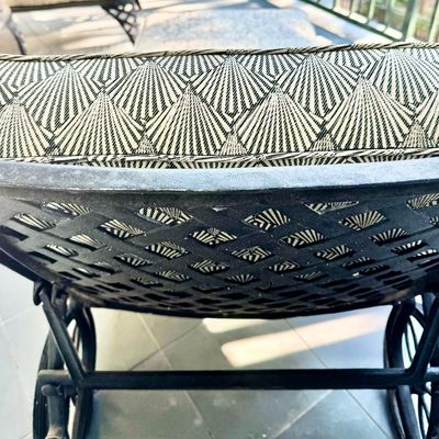 Sale Photo Thumbnail #283: This  pair of vintage chaise lounges features a durable cast aluminum frame finished in a matte black powder coat, characterized by intricate, lattice-style openwork on the frame and legs. This piece is mounted on two functional wheels, facilitating easy 