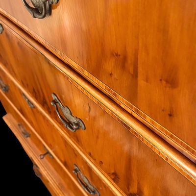 Sale Photo Thumbnail #106: This exquisite Queen Anne style highboy features a classic bonnet-top (or swan's neck) pediment adorned with a central carved shell motif and finials. The piece is constructed with rich, figured walnut veneers, showcasing intricate grain patterns across t