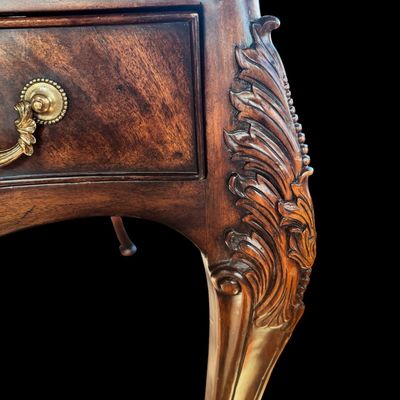 Sale Photo Thumbnail #76: This is a stunning Theodore Alexander partners style writing desk constructed with solid mahogany wood with a beautiful leather tooled top. A rich warm finish showcases the natural grain pattern. The front features a series of 4 drawers equipped with orna