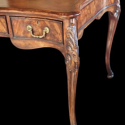 Sale Photo Thumbnail #69: This is a stunning Theodore Alexander partners style writing desk constructed with solid mahogany wood with a beautiful leather tooled top. A rich warm finish showcases the natural grain pattern. The front features a series of 4 drawers equipped with orna