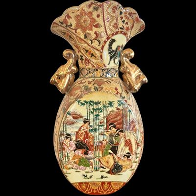 Sale Photo Thumbnail #258: This exquisite pair of Satsuma earthenware vases are characterized by their intricate, multi-colored enamel decoration on a crackle grazed ground. The vase is distinguished by its unique elephant head handles finished in a rich gold luster, reflecting the