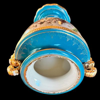 Sale Photo Thumbnail #251: This large decorative French urn features a vibrant teal glazed neck and base, accented with ornate gilded details and handles. The body is decorated with a detailed, hand painted 18th century courting scene. Neo classical design from the late 19th/early 