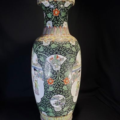Sale Photo Thumbnail #254: Pair of large, decorative Chinese porcelain vase featuring a black-ground ‘Famille Noire’ palette. The vase showcases intricate polychrome enamel decoration, depicting courtly figures in a garden setting, framed by dense floral and foliate patterns on