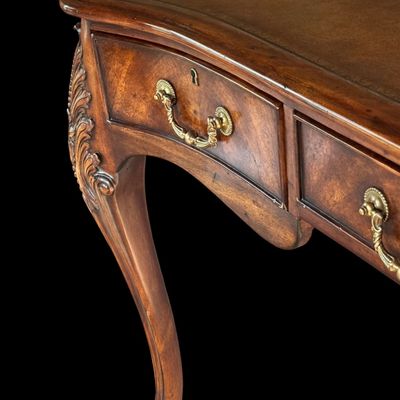 Sale Photo Thumbnail #68: This is a stunning Theodore Alexander partners style writing desk constructed with solid mahogany wood with a beautiful leather tooled top. A rich warm finish showcases the natural grain pattern. The front features a series of 4 drawers equipped with orna