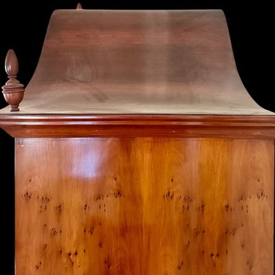 Sale Photo Thumbnail #111: This exquisite Queen Anne style highboy features a classic bonnet-top (or swan's neck) pediment adorned with a central carved shell motif and finials. The piece is constructed with rich, figured walnut veneers, showcasing intricate grain patterns across t