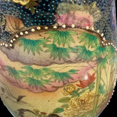 Sale Photo Thumbnail #264: Chinese Satsuma earthenware characterized by its crackle glaze and dense, polychrome enamel decoration. The vase features a lobed rim and a classic baluster form. The body is adorned with intricate scenes including cranes~ a symbol of longevity, flower mo