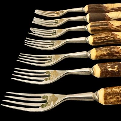 Sale Photo Thumbnail #221: Cutlery makers in the town of Solingen, Germany, produced specialized hunting flatware with natural horn handles for export and domestic markets. These sets were crafted during the mid-20th century to satisfy a strong demand for rustic, outdoor-themed din