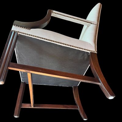 Sale Photo Thumbnail #156: Handsome pair of Chippendale style arm chairs featuring a high, slightly arched back and fluted, dark stained wooden arms and legs. The chairs are upholstered in a neutral chevron pattern fabric, accented with decorative brass tone nailhead trim along the