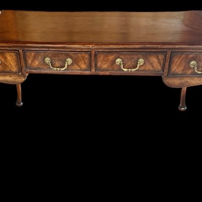 Sale Photo Thumbnail #63: This is a stunning Theodore Alexander partners style writing desk constructed with solid mahogany wood with a beautiful leather tooled top. A rich warm finish showcases the natural grain pattern. The front features a series of 4 drawers equipped with orna